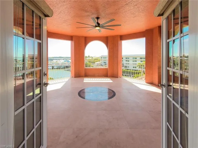 Unfurnished sunroom with french doors, a water view, and plenty of natural light
