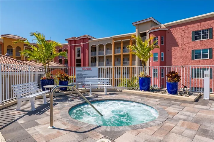 View of swimming pool with a community hot tub and patio surround