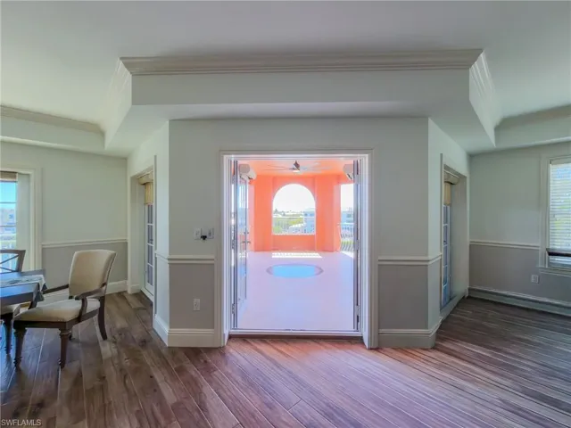 Foyer entrance featuring dark wood-type flooring and ornamental molding
