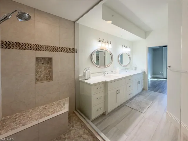 Bathroom featuring double vanity and walk in shower