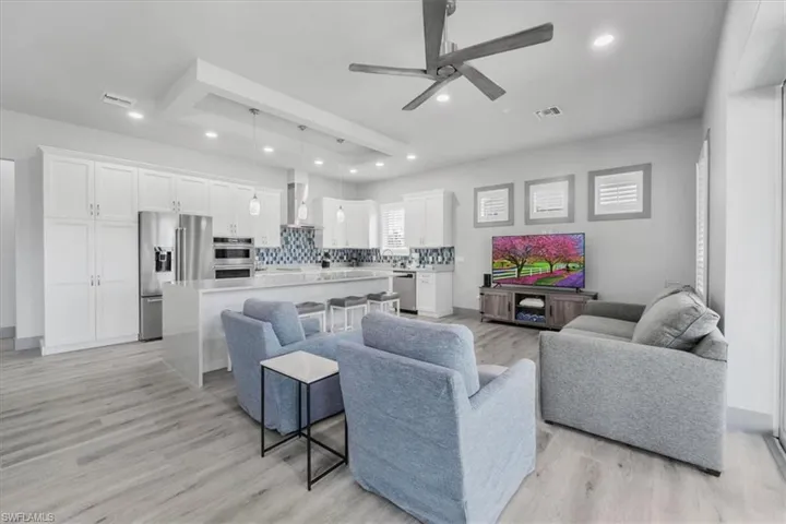 Living room featuring ceiling fan and light wood-type flooring
