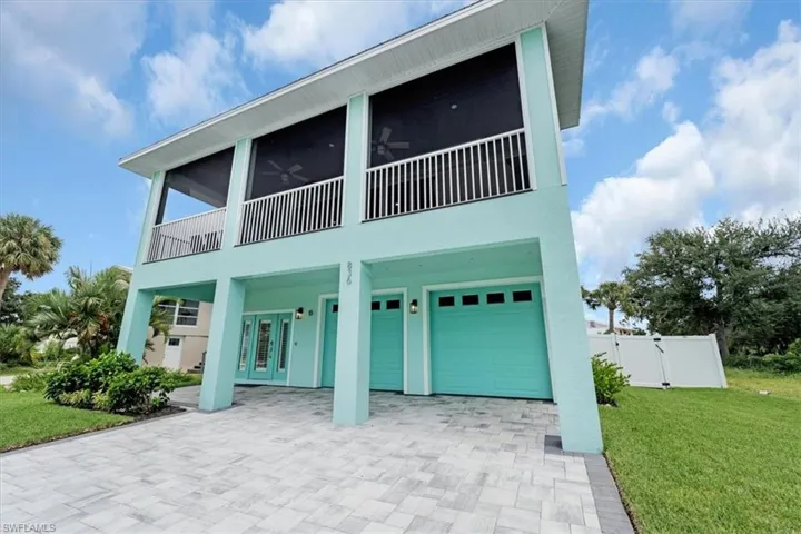 View of front of property with a front lawn and a garage
