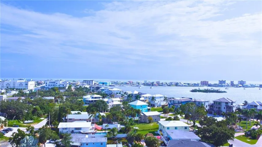 Birds eye view of property with a water view