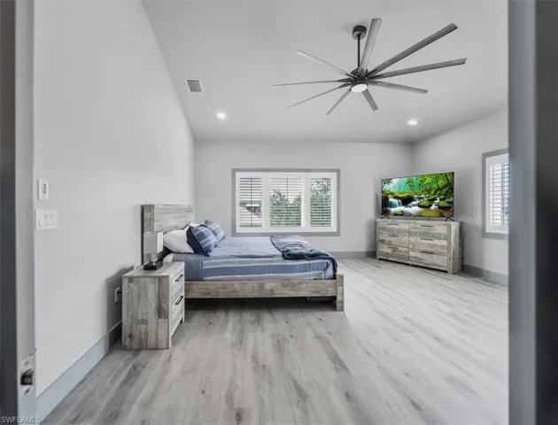 Bedroom with ceiling fan and light hardwood / wood-style flooring