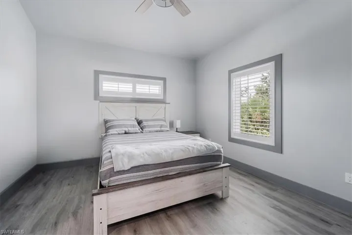Bedroom with ceiling fan and wood-type flooring