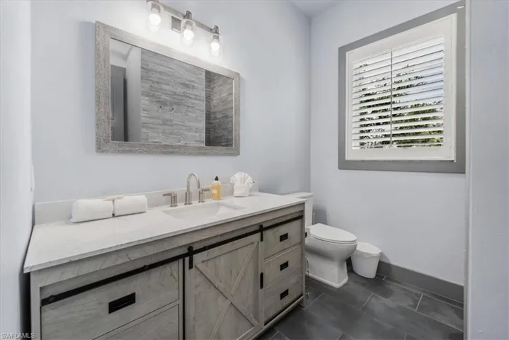 Bathroom with tile patterned floors, vanity, and toilet