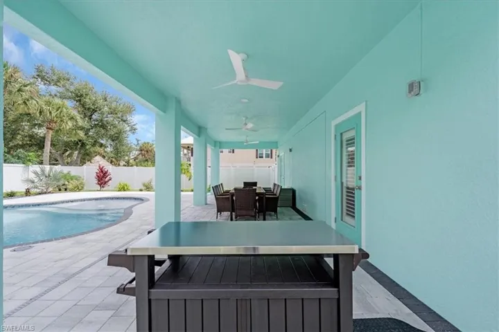 View of patio / terrace featuring ceiling fan and a fenced in pool