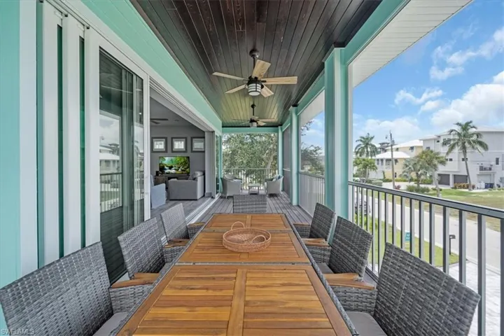 Sunroom / solarium featuring ceiling fan, wooden ceiling, and a healthy amount of sunlight