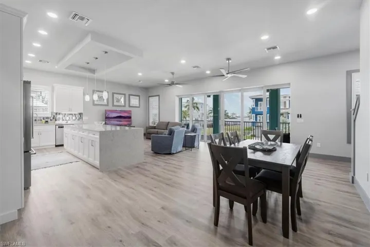 Dining room with ceiling fan, french doors, and light hardwood / wood-style floors