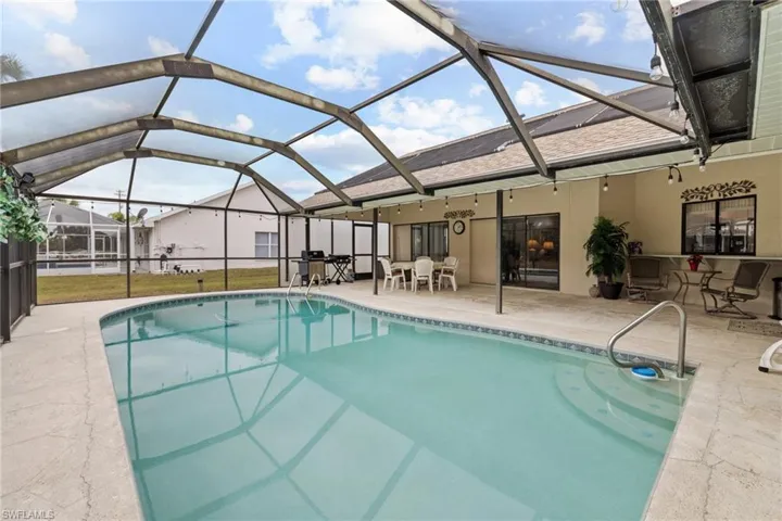 View of swimming pool with a patio area and a lanai