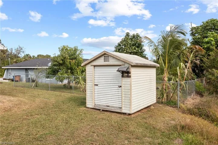 View of outbuilding featuring a lawn