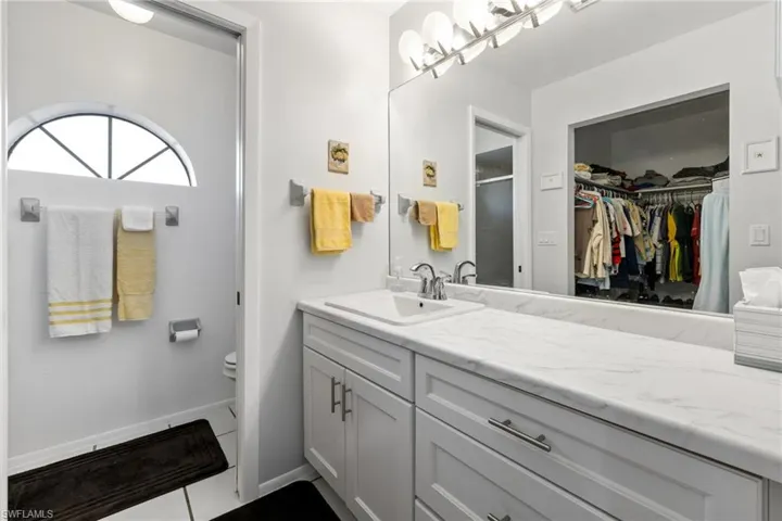 Bathroom with tile patterned flooring, vanity, and toilet