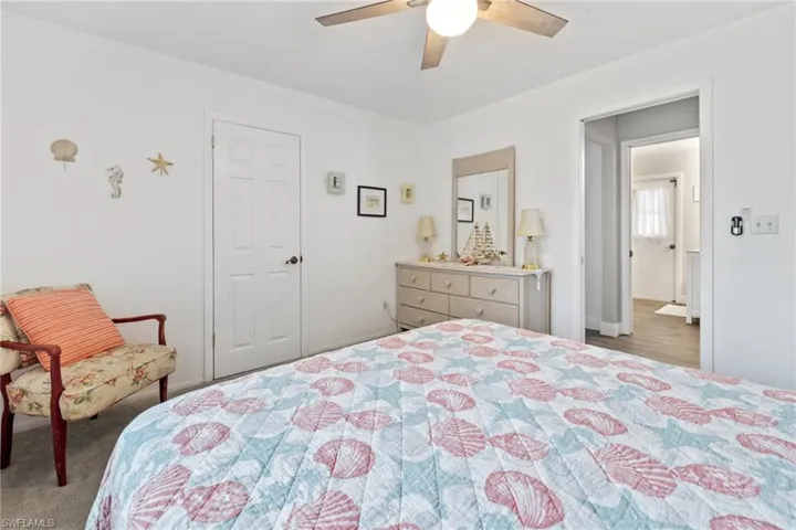 Carpeted bedroom with ceiling fan