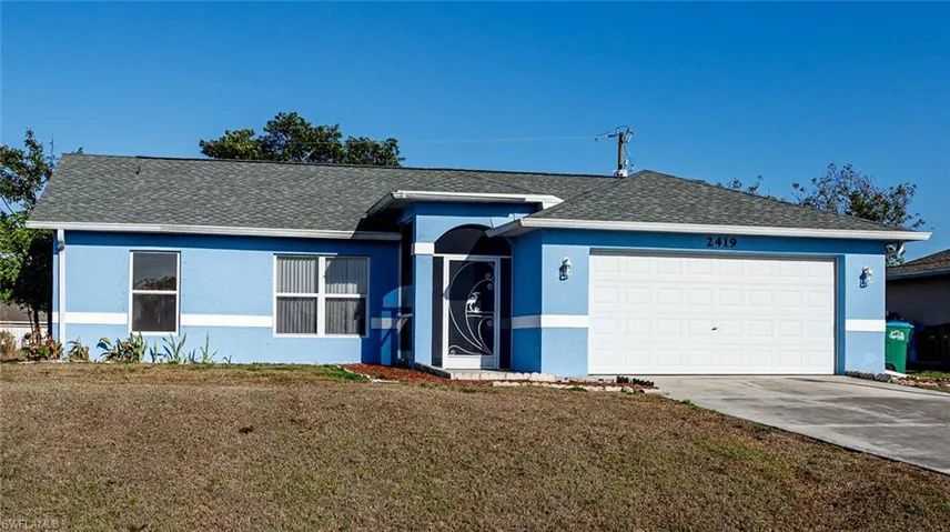 Ranch-style home with a shingled roof, a garage, stucco siding, and concrete driveway