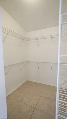 Walk in closet with light tile patterned floors