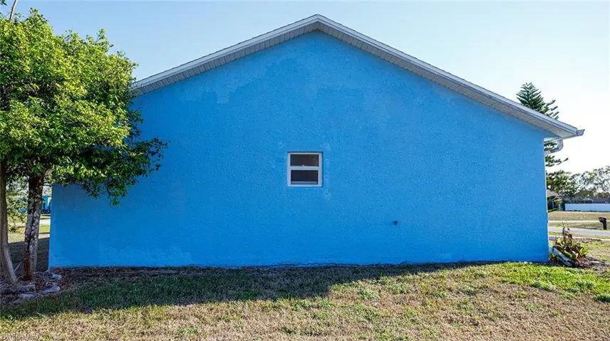 View of property exterior with a lawn