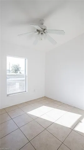 Unfurnished room featuring a ceiling fan and light tile patterned flooring