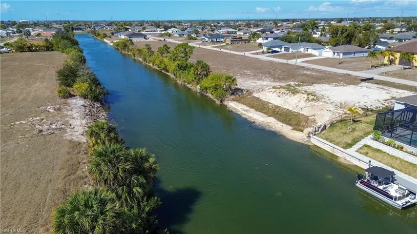 Aerial perspective of suburban area featuring a large body of water