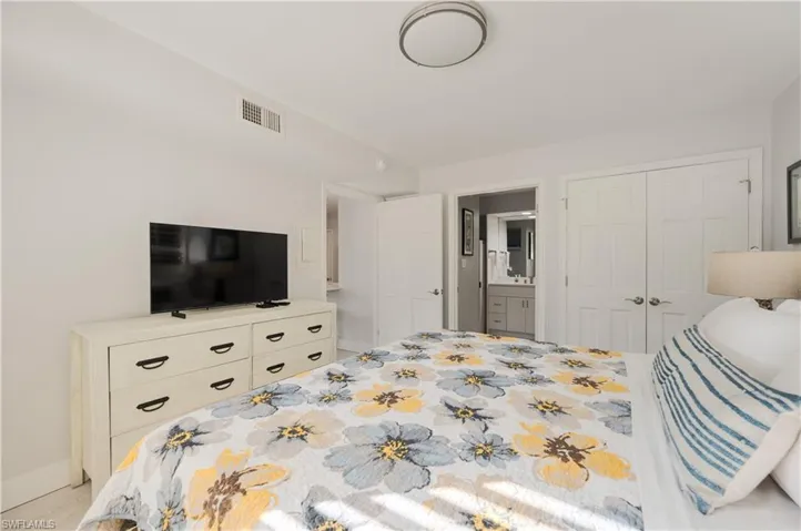 Bedroom featuring ensuite bathroom and a closet