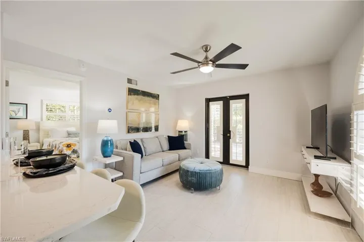 Living room featuring ceiling fan and a healthy amount of sunlight