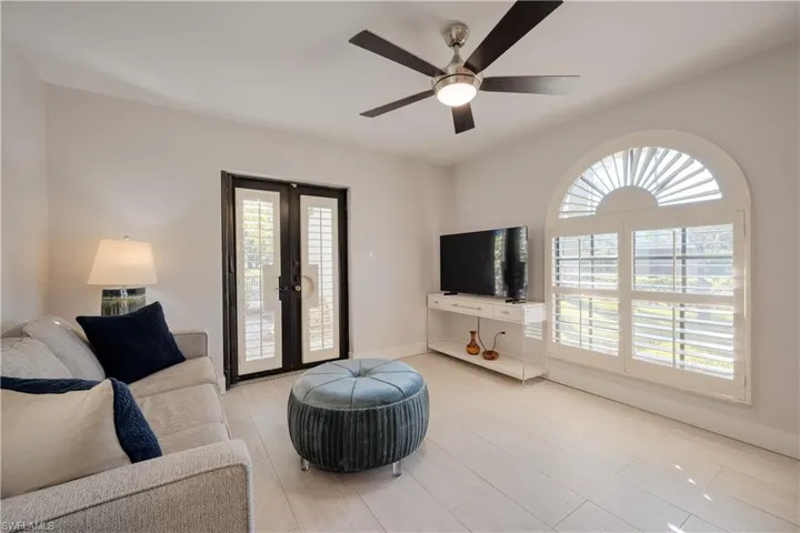 Living room with ceiling fan and french doors