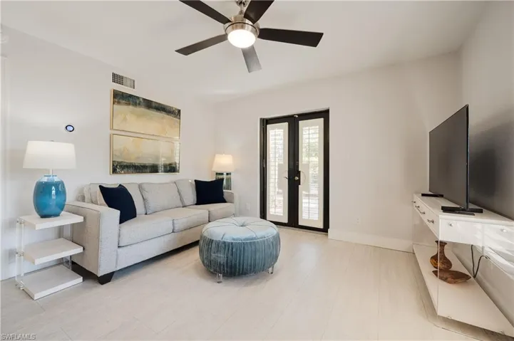 Living room with french doors and ceiling fan