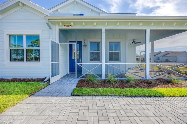 Front entrance view with wraparound porch with preserve view.