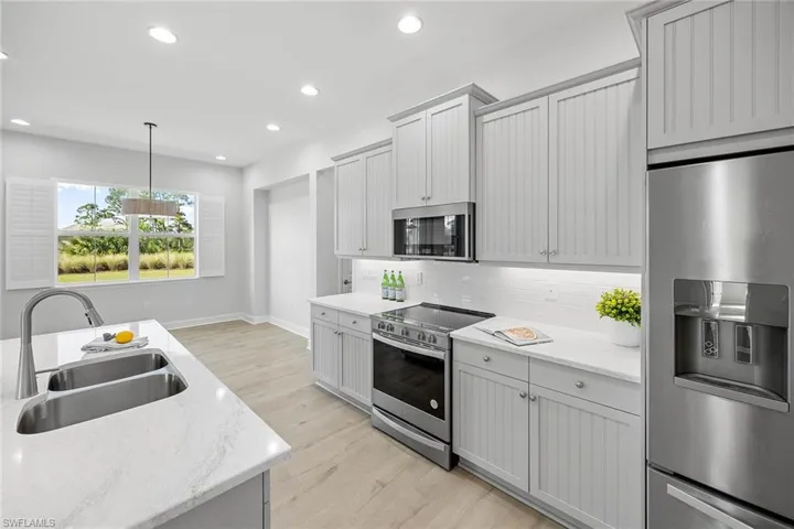 Kitchen Island with Quartz Countertops and stainless steel appliances.