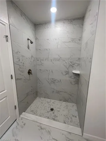 Bathroom featuring a tile shower