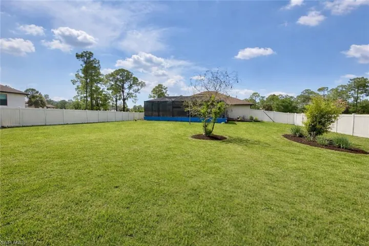 Half acre fenced backyard.