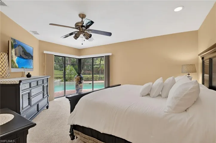 Bedroom featuring carpet, access to exterior, and ceiling fan