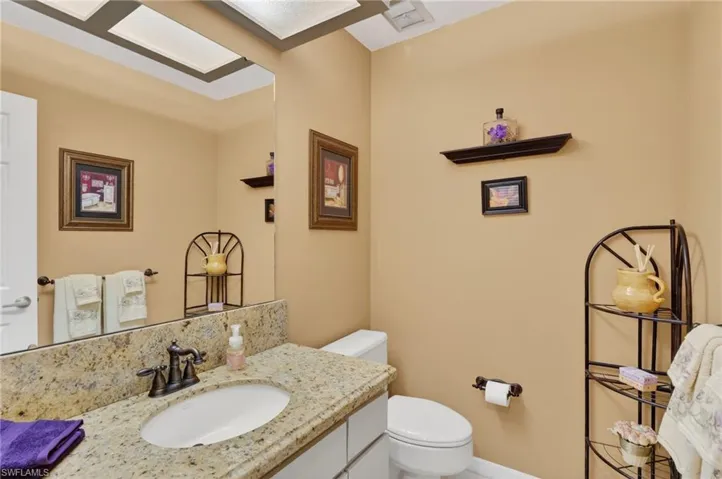 Half bath featuring vanity and toilet