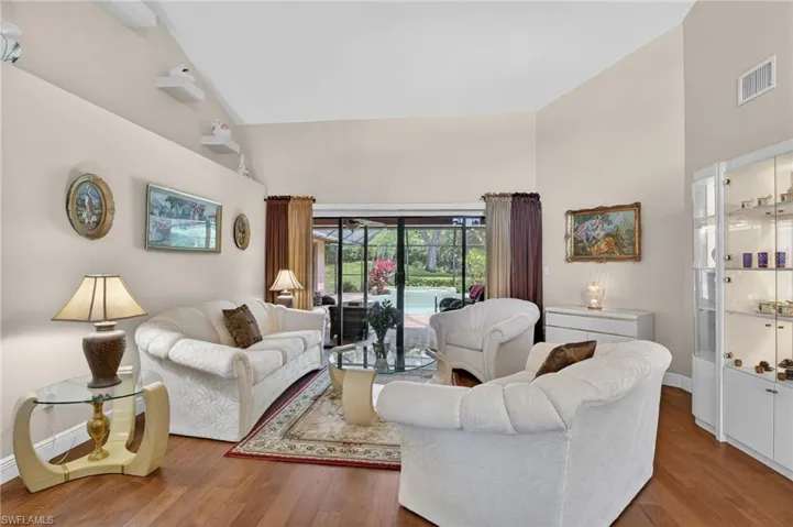 Living area featuring wood finished floors and lofted ceiling