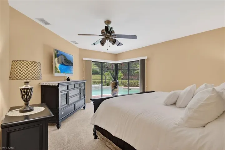 Bedroom featuring light colored carpet, access to outside, and a ceiling fan
