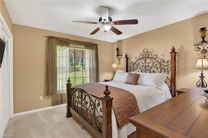 Bedroom featuring carpet floors, ceiling fan, and a closet