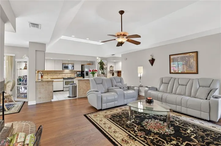 Living area featuring light wood-style flooring, recessed lighting, and ceiling fan