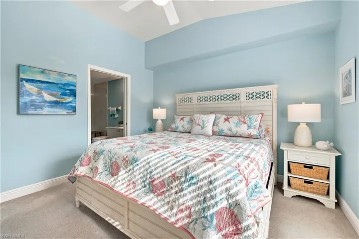 Recessed lighting, ceiling fan, carpeted flooring, and a white paneled bed frame with decorative headboard