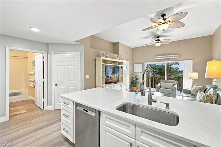 Kitchen island with a built-in stainless steel sink and a gooseneck faucet