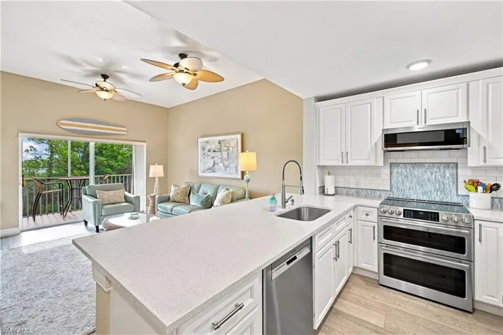 White shaker cabinetry, stainless steel appliances, and a solid surface countertop