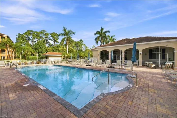 Outdoor swimming pool with integrated spa and brick paver decking