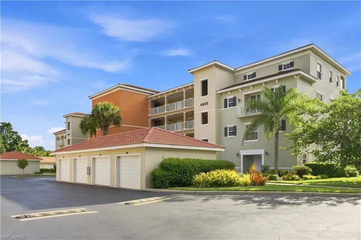 Multi-story building with a stucco exterior and tiled roofs