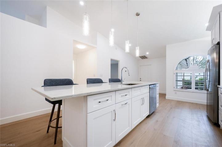 Large Breakfast Bar/Island with Granite Counter Top and Designer Pendant lighting.