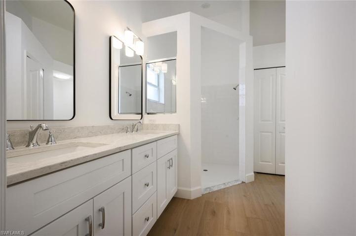 Master Bathroom with double sinks, custom mirrors and walk in tile shower