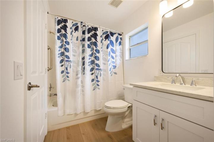 Guest Bathroom, with new custom cabinet, granite counter top and designer mirror