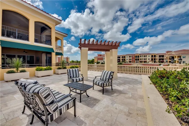 View of patio with a balcony