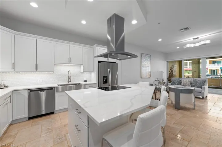 Kitchen with sink, a kitchen island, island range hood, white cabinetry, and stainless steel appliances