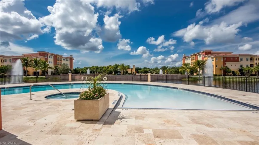 View of swimming pool featuring a patio and a community hot tub