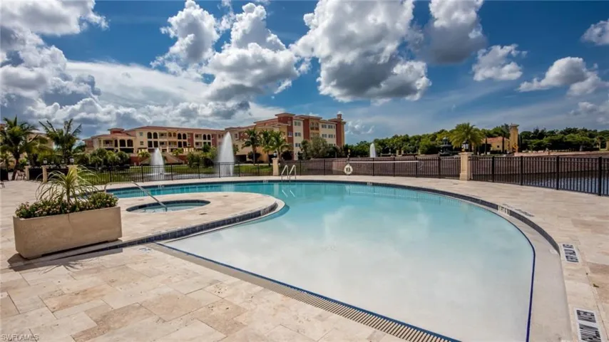 View of pool featuring a hot tub and a patio area