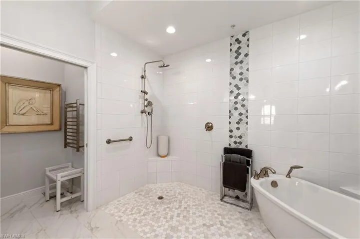 Bathroom featuring shower with separate bathtub
