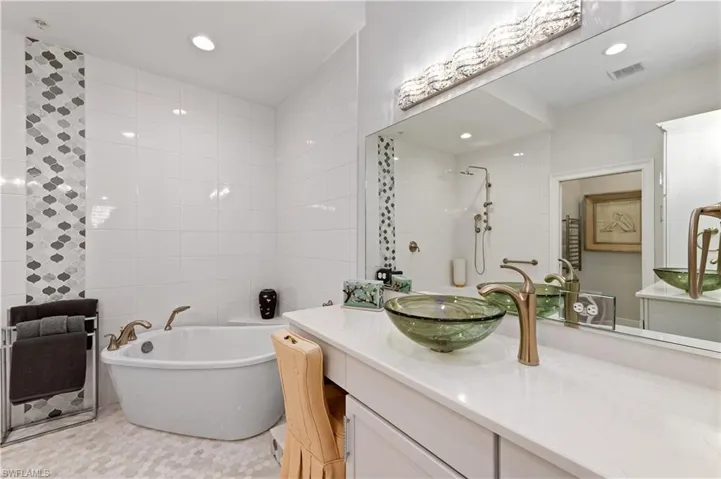 Bathroom with vanity and plus walk in shower